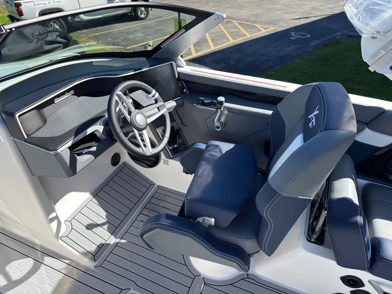 Slide: The Image of The image shows the cockpit of a 2027 MasterCraft XT22 with a modern steering wheel and blue seats. - 38