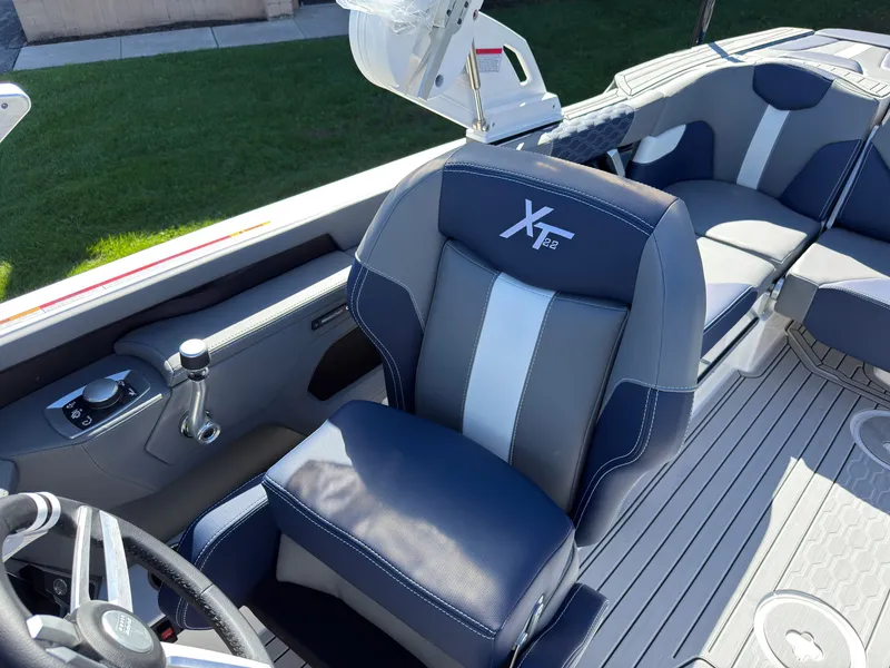 Slide: The Image of The image shows the interior of a MasterCraft XT22 boat with modern seating and controls. - 37
