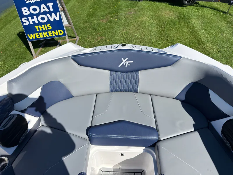Slide: The Image of The image shows the cockpit of a MasterCraft XT22 with gray and blue upholstery. - 17