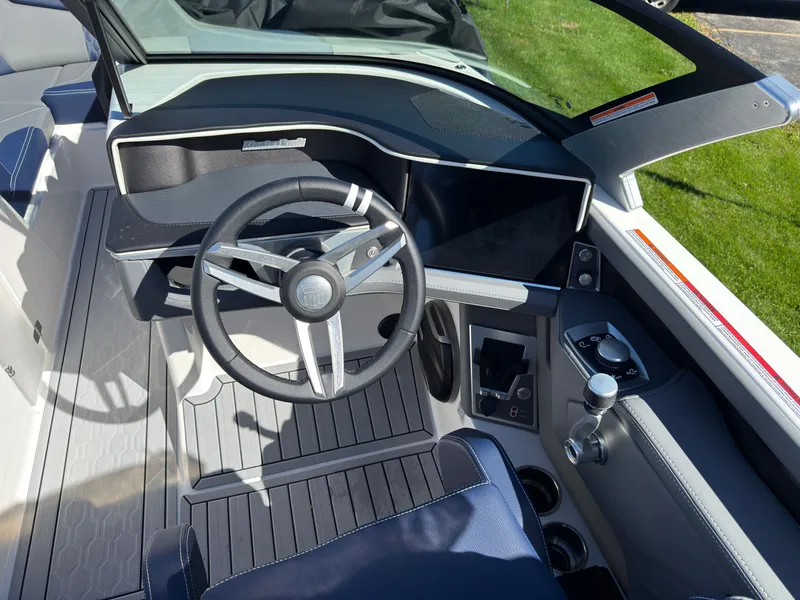 Slide: The Image of The image shows the cockpit of a 2027 MasterCraft XT22 with a modern steering wheel and dashboard. - 35