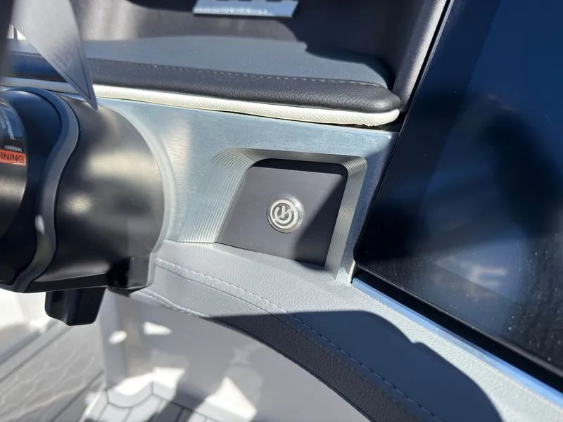 Slide: The Image of Close-up of a MasterCraft XT22 boat dashboard with a start button. - 31