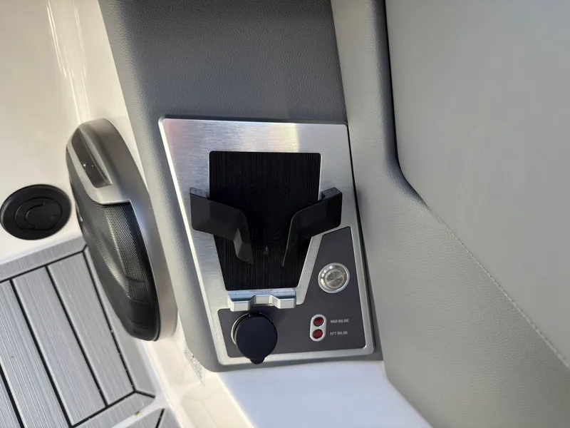 Slide: The Image of Close-up of a boat control panel with a cup holder and controls. - 25