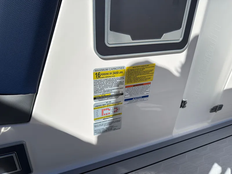 Slide: The Image of Close-up of a boat with capacity labels for 16 persons or 2400 pounds. - 24