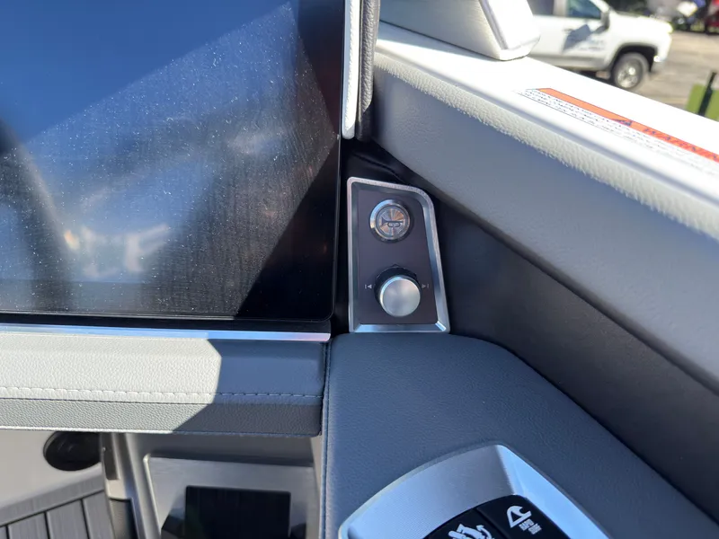 Slide: The Image of Close-up of the helm area of a MasterCraft XT22 boat with modern controls. - 28