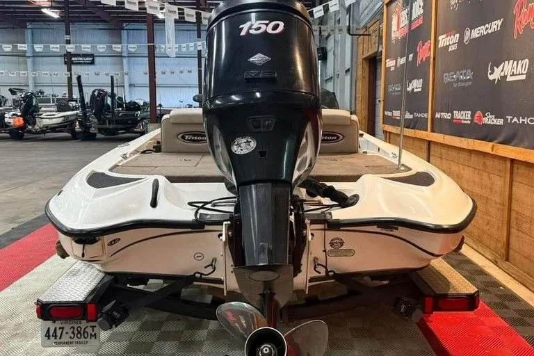 Slide: The Image of 2007 Triton Tr-186 boat with 150 HP engine displayed indoors. - 5