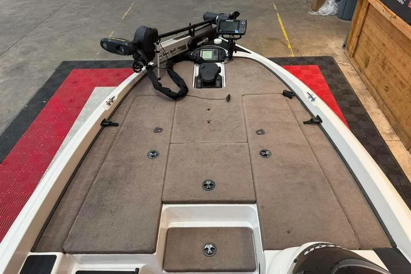 Slide: The Image of 2007 Triton Tr-186 boat deck with mounted equipment and carpeted surface. - 7