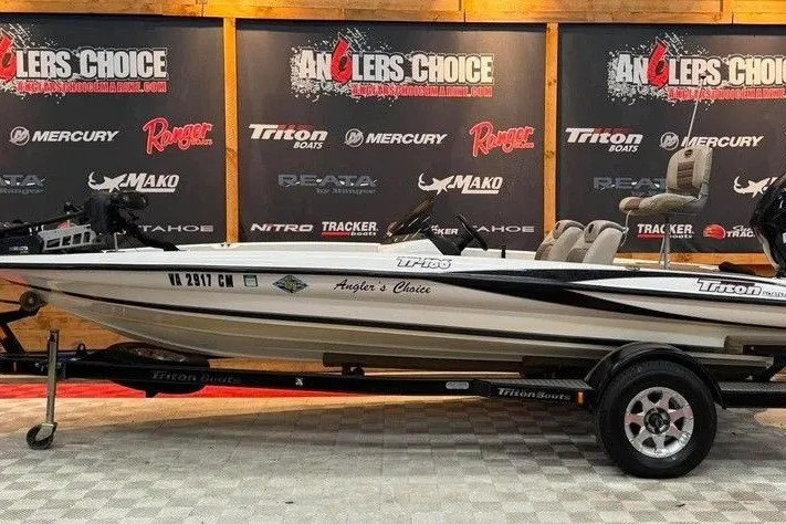 The Image of 2007 Triton Tr-186 boat displayed at Angler's Choice showroom with branded backdrop. - 0