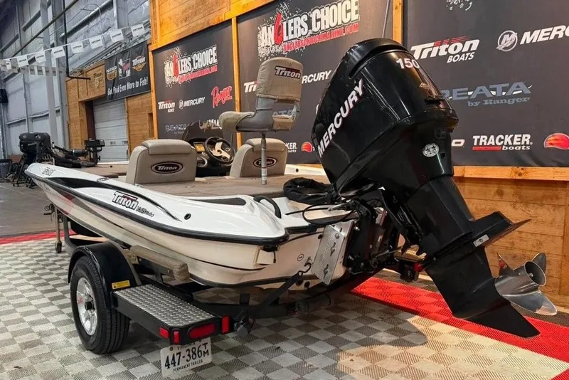 Slide: The Image of 2007 Triton Tr-186 boat with Mercury engine displayed indoors on checkered flooring. - 1