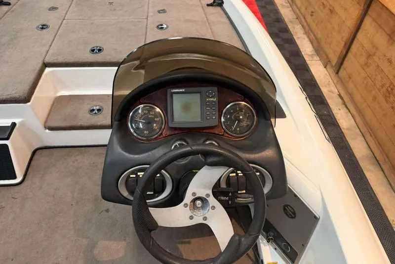 Slide: The Image of 2007 Triton Tr-186 boat dashboard with steering wheel and gauges. - 4