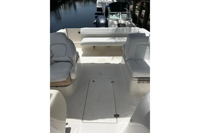 Slide: The Image of 2016 Robalo R227 Dual Console boat interior with white seating and spacious deck. - 9