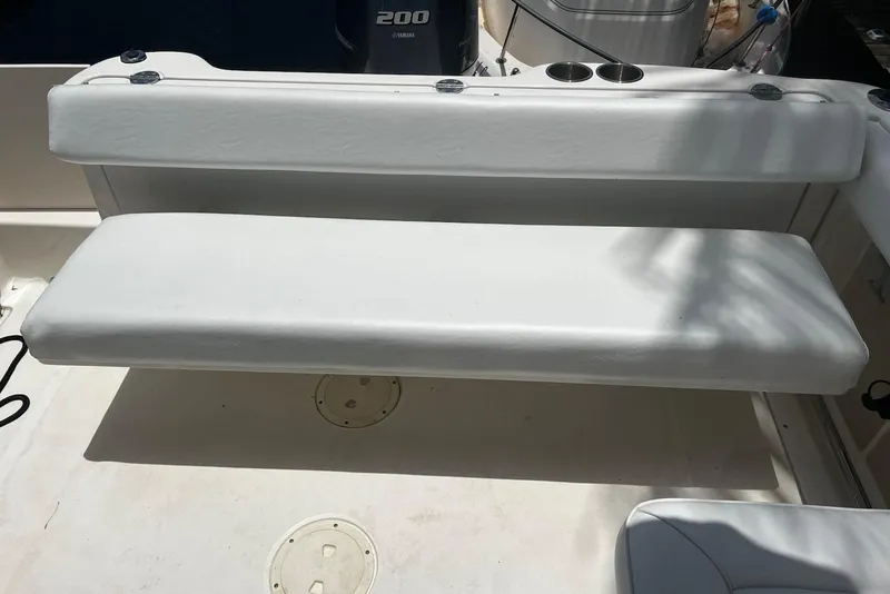 Slide: The Image of 2016 Robalo R227 Dual Console boat seating with Yamaha 200 engine in background. - 10