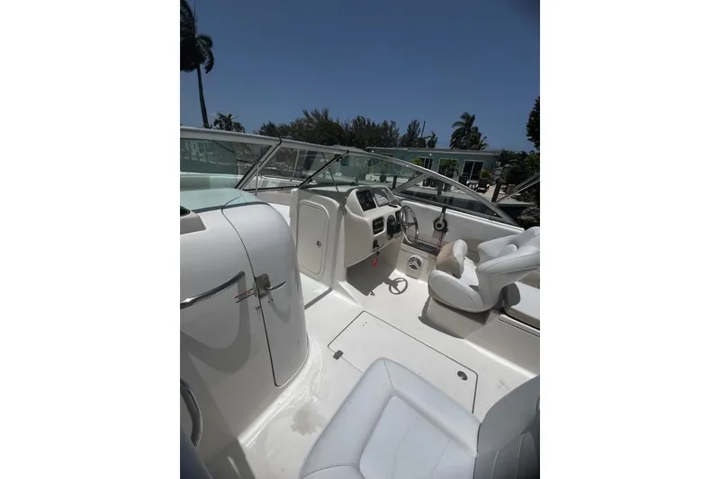 Slide: The Image of 2016 Robalo R227 Dual Console boat interior with steering wheel and seating. - 4