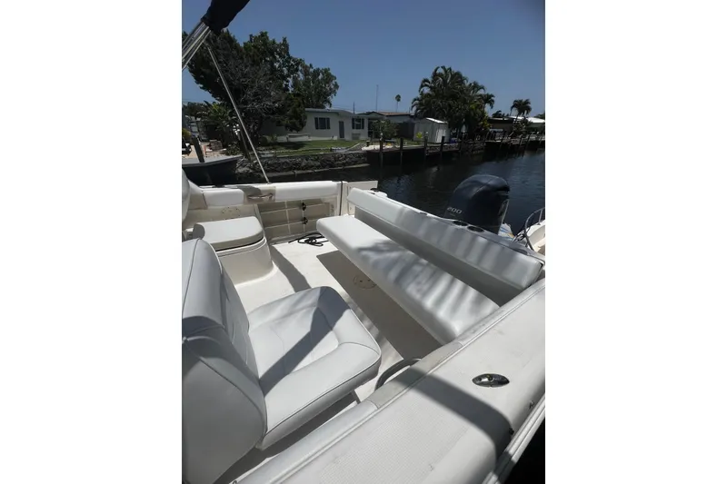 Slide: The Image of 2016 Robalo R227 Dual Console boat interior with seating and outboard motor. - 6