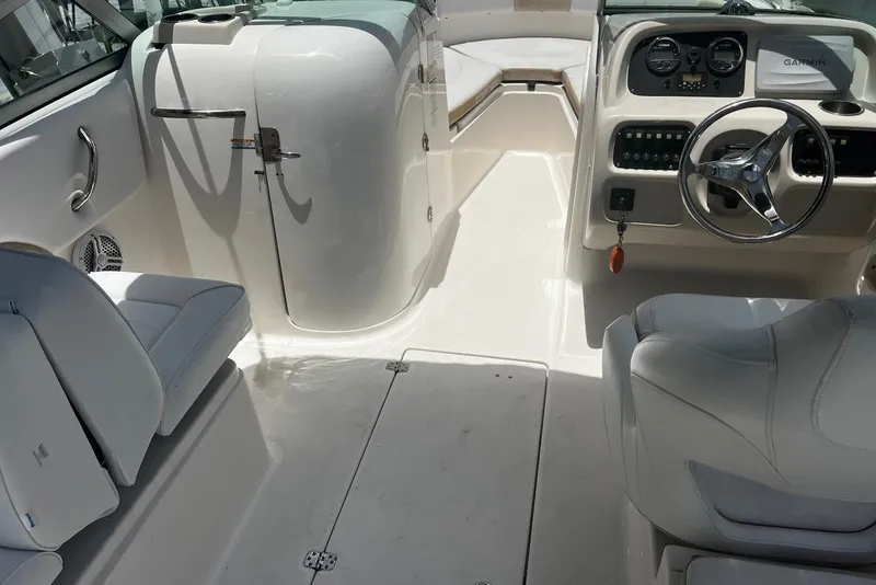 Slide: The Image of 2016 Robalo R227 Dual Console boat interior with steering wheel and seating. - 12