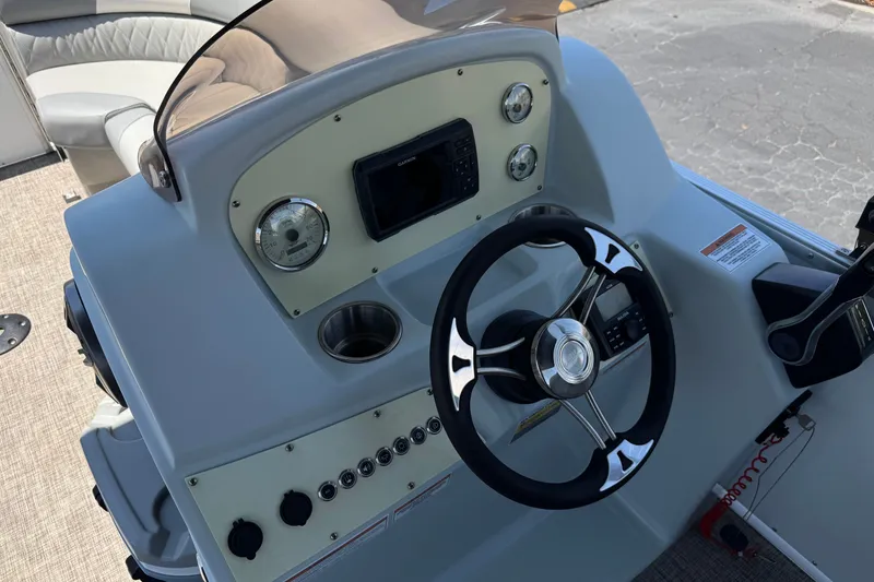 Slide: The Image of 2024 Lexington Emerg 17 Palm Breeze boat dashboard with steering wheel and controls. - 21