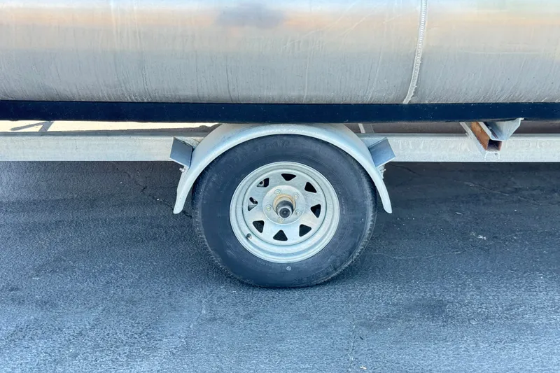 Slide: The Image of Trailer wheel of 2024 Lexington Emerg 17 Palm Breeze on asphalt surface. - 24