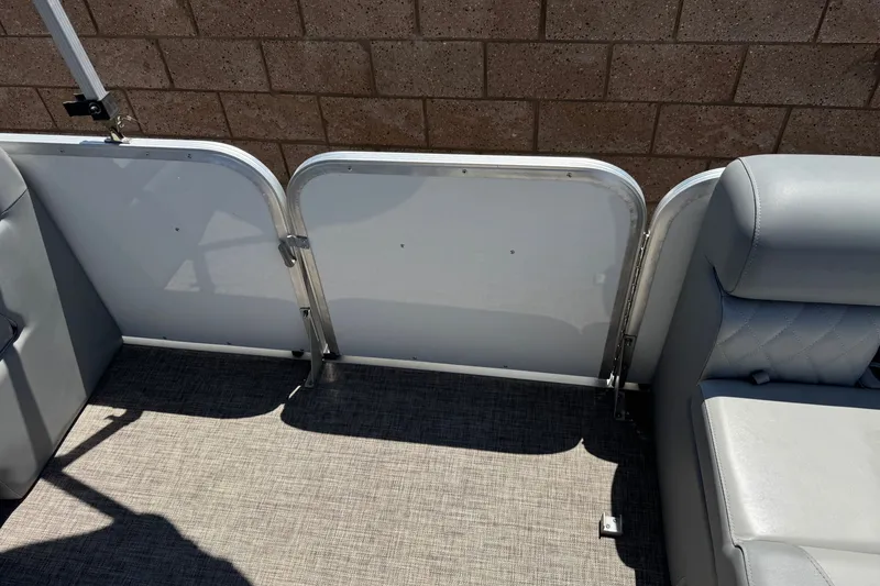 Slide: The Image of 2024 Lexington Emerg 17 Palm Breeze boat interior with gray seating and flooring. - 13