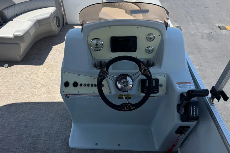 Slide: The Image of 2024 Lexington Emerg 17 Palm Breeze boat dashboard with steering wheel and controls. - 20