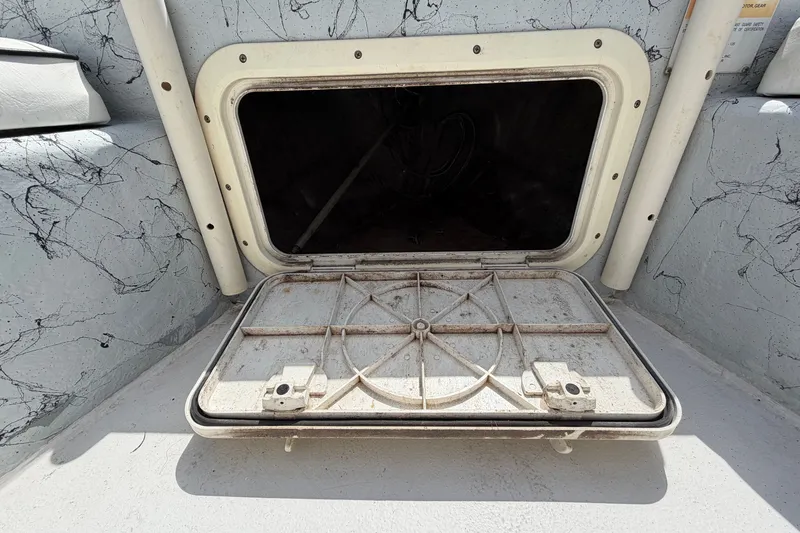 Slide: The Image of Open storage compartment on a 2004 Kenner 180VX Tunnel boat. - 14