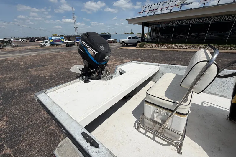 Slide: The Image of 2004 Kenner 180VX Tunnel boat with Mercury outboard motor, parked outside showroom. - 20