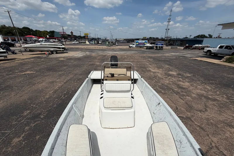 Slide: The Image of 2004 Kenner 180VX Tunnel boat on a paved lot under a partly cloudy sky. - 15