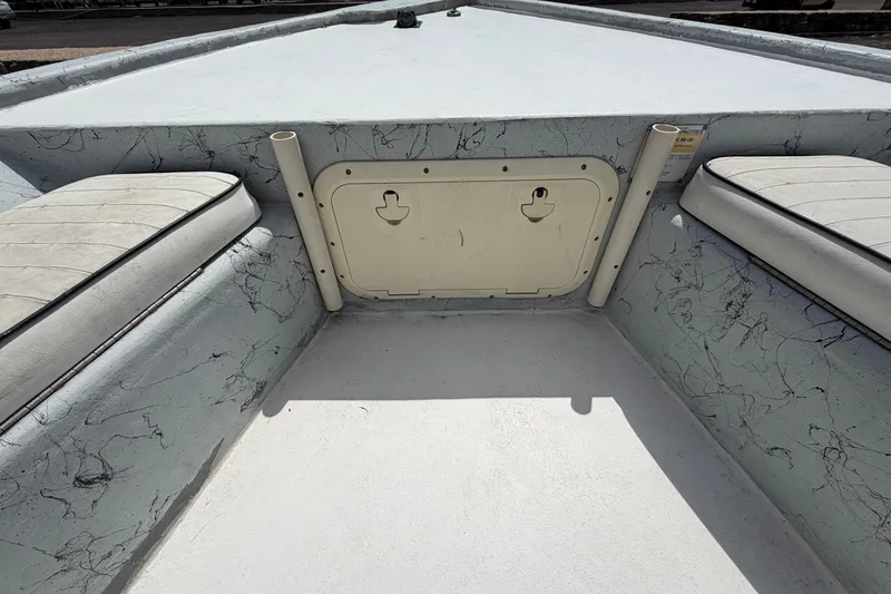 Slide: The Image of 2004 Kenner 180VX Tunnel boat interior with storage compartment and seating. - 13