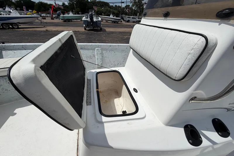 Slide: The Image of 2004 Kenner 180VX Tunnel boat with open storage compartment and cushioned seating. - 17