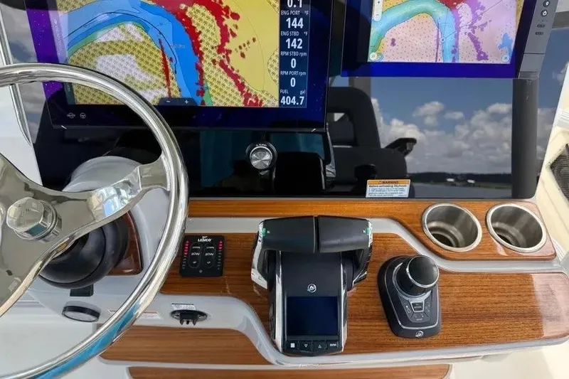 Slide: The Image of Helm of 2024 Boston Whaler 380 Outrage with advanced navigation displays and controls. - 24