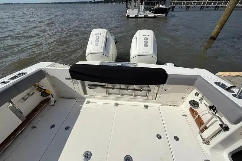 Slide: The Image of 2024 Boston Whaler 380 Outrage boat deck with dual engines on water. - 22
