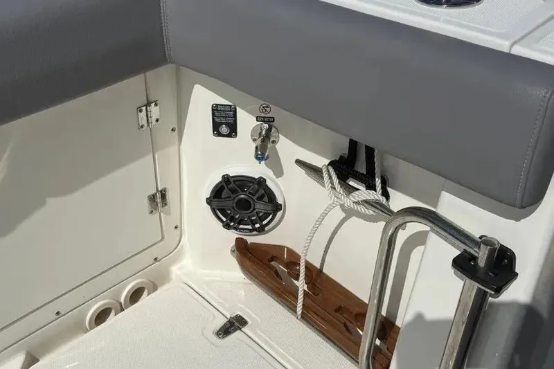 Slide: The Image of Interior detail of 2024 Boston Whaler 380 Outrage boat, featuring speaker and rope storage. - 18
