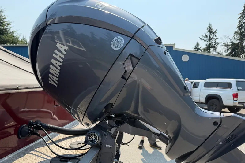 Slide: The Image of 2024 Hewescraft 210 Sea Runner ET with Yamaha outboard motor, parked outdoors. - 21