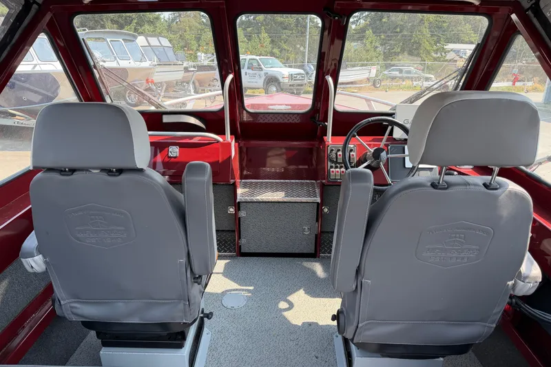 Slide: The Image of Interior of 2024 Hewescraft 210 Sea Runner ET, featuring dual gray seats and steering console. - 4