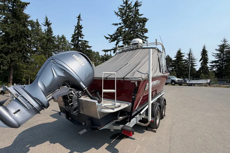 Slide: The Image of 2024 Hewescraft 210 Sea Runner ET with Yamaha outboard motor, parked outdoors. - 18