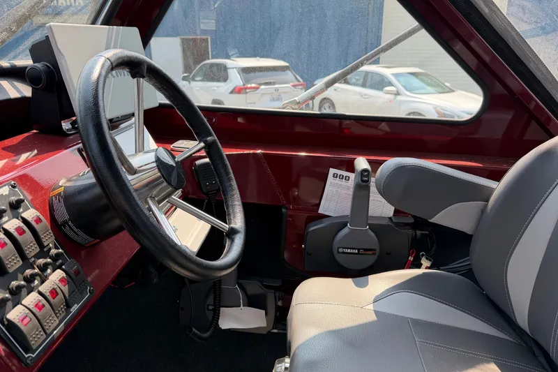 Slide: The Image of Interior of 2024 Hewescraft 210 Sea Runner ET boat, featuring steering wheel and controls. - 6