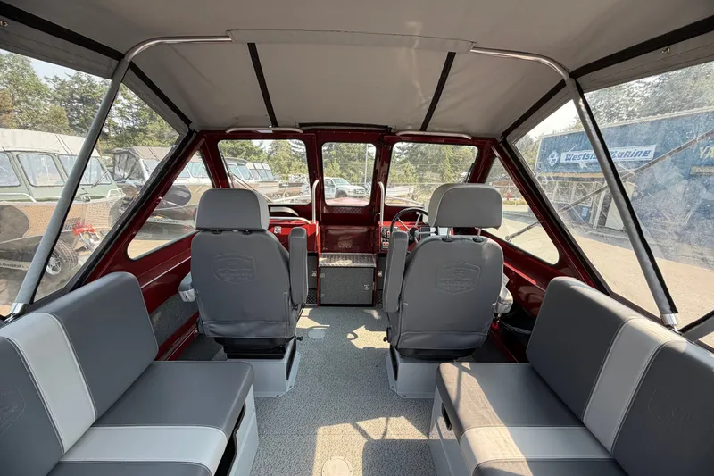 Slide: The Image of Interior of 2024 Hewescraft 210 Sea Runner ET boat, featuring seating and steering area. - 3