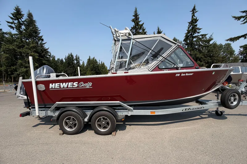 The Image of 2024 Hewescraft 210 Sea Runner ET boat on trailer, parked outdoors. - 0