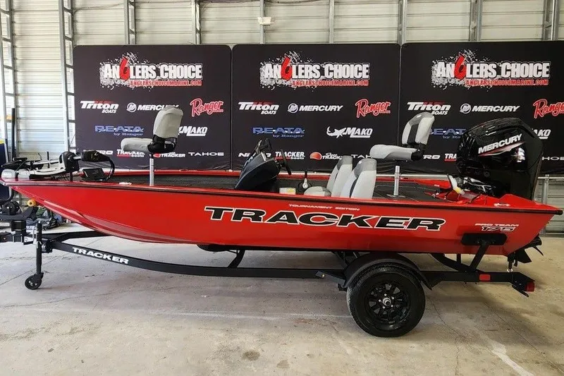The Image of 2027 Tracker Grizzly 1860 CC boat in showroom, red color, displayed on trailer. - 1