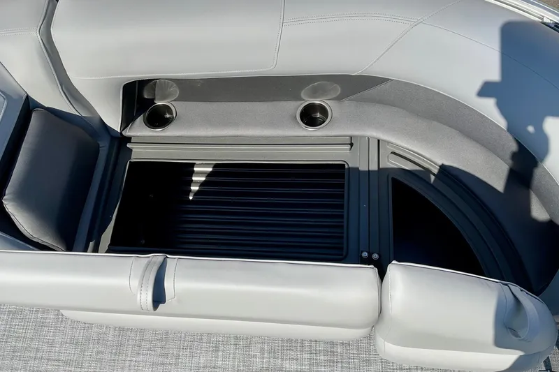 Slide: The Image of 2026 Sun Tracker Party Barge 18 DLX interior with cup holders and seating. - 13