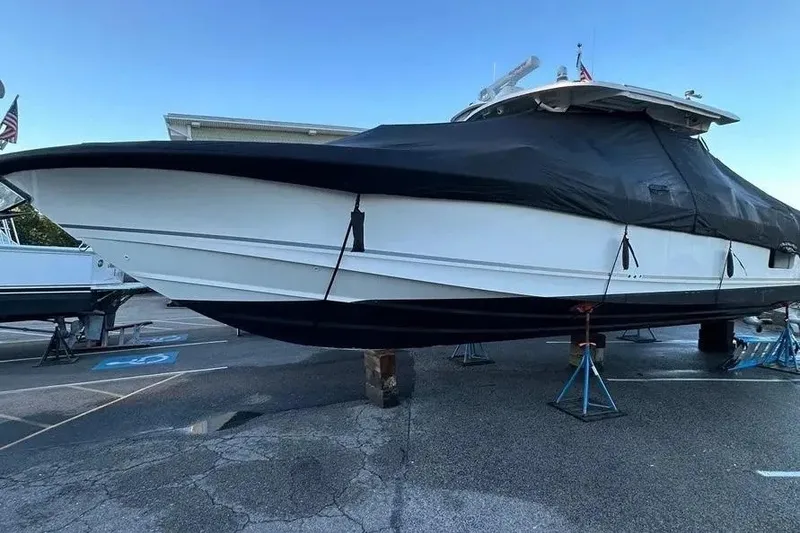 Slide: The Image of 2021 Boston Whaler 380 Outrage boat covered and elevated on stands. - 12