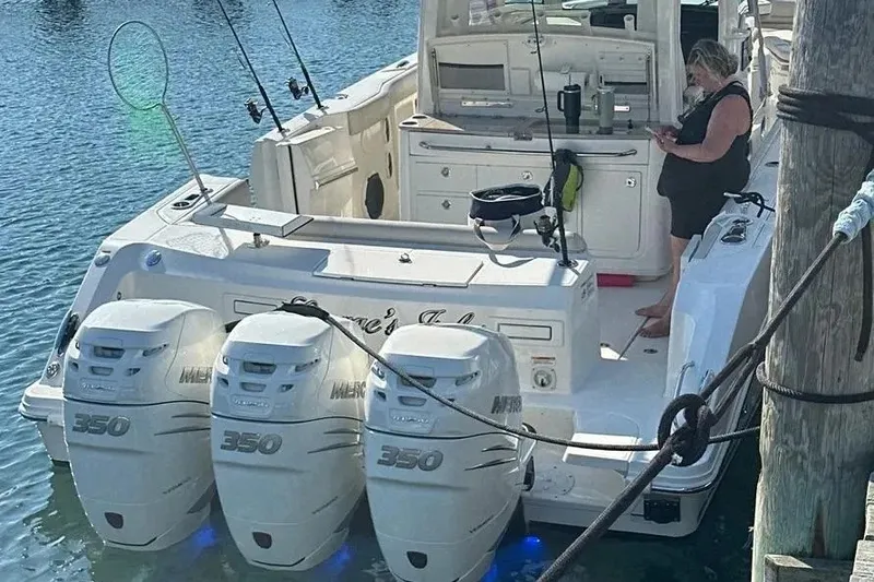Slide: The Image of 2021 Boston Whaler 380 Outrage with triple Mercury 350 engines docked at marina. - 9