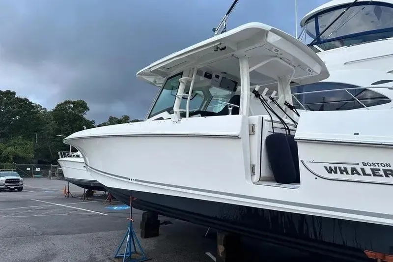Slide: The Image of 2021 Boston Whaler 380 Outrage boat on stands in a parking lot. - 5