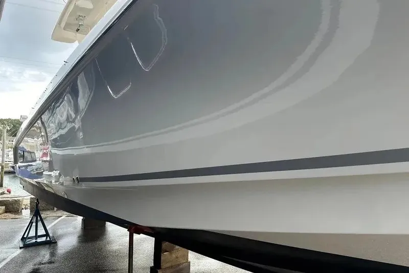 Slide: The Image of 2021 Boston Whaler 380 Outrage boat hull on stands, side view. - 6
