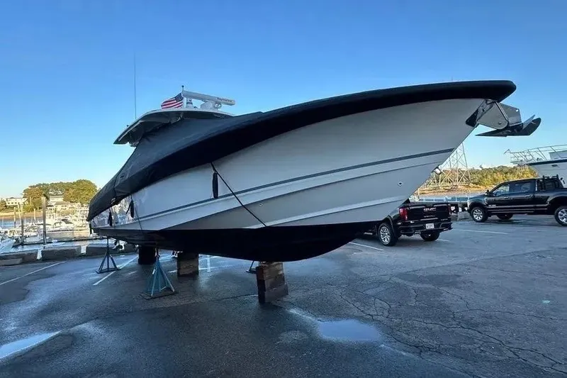 Slide: The Image of 2021 Boston Whaler 380 Outrage boat on stands in a marina setting. - 13