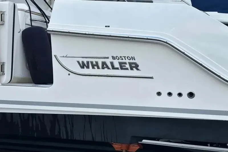 Slide: The Image of 2021 Boston Whaler 380 Outrage boat side view with logo and details. - 4