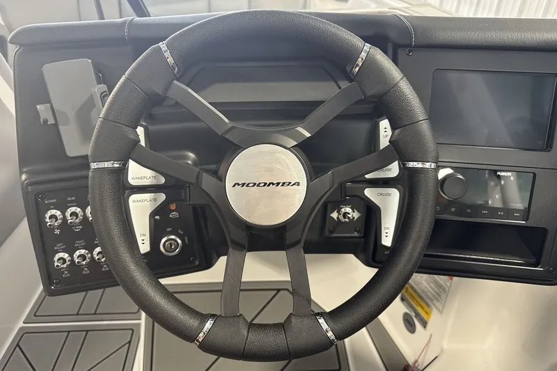 Slide: The Image of Steering wheel of 2027 Moomba Max boat with control panel and touchscreen display. - 14