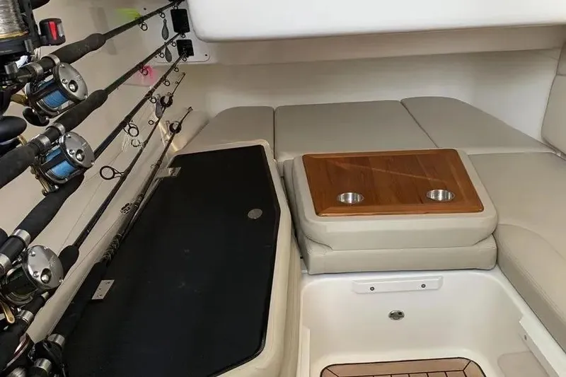Slide: The Image of Interior of a 2019 Boston Whaler 380 Outrage with fishing rods and cushioned seating. - 29
