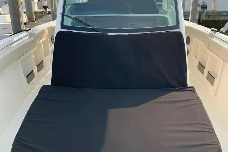 Slide: The Image of 2019 Boston Whaler 380 Outrage boat with black seat cover on deck. - 48