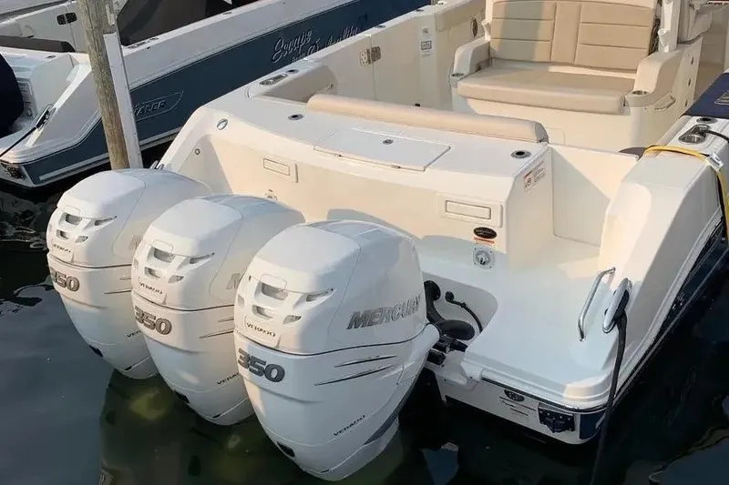 Slide: The Image of 2019 Boston Whaler 380 Outrage with triple Mercury 350 engines docked in marina. - 39