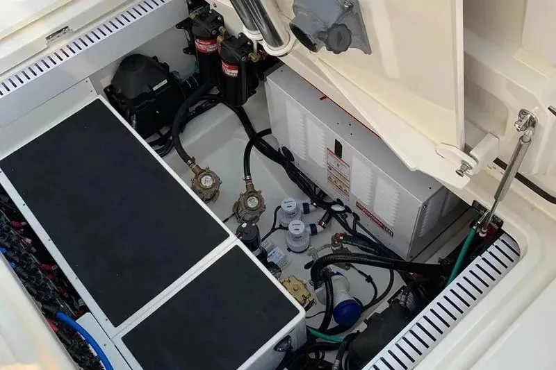 Slide: The Image of 2019 Boston Whaler 380 Outrage engine compartment with wiring and components visible. - 24
