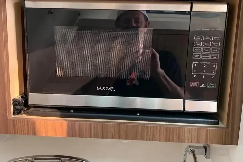 Slide: The Image of Microwave oven inside a 2019 Boston Whaler 380 Outrage boat kitchen area. - 26